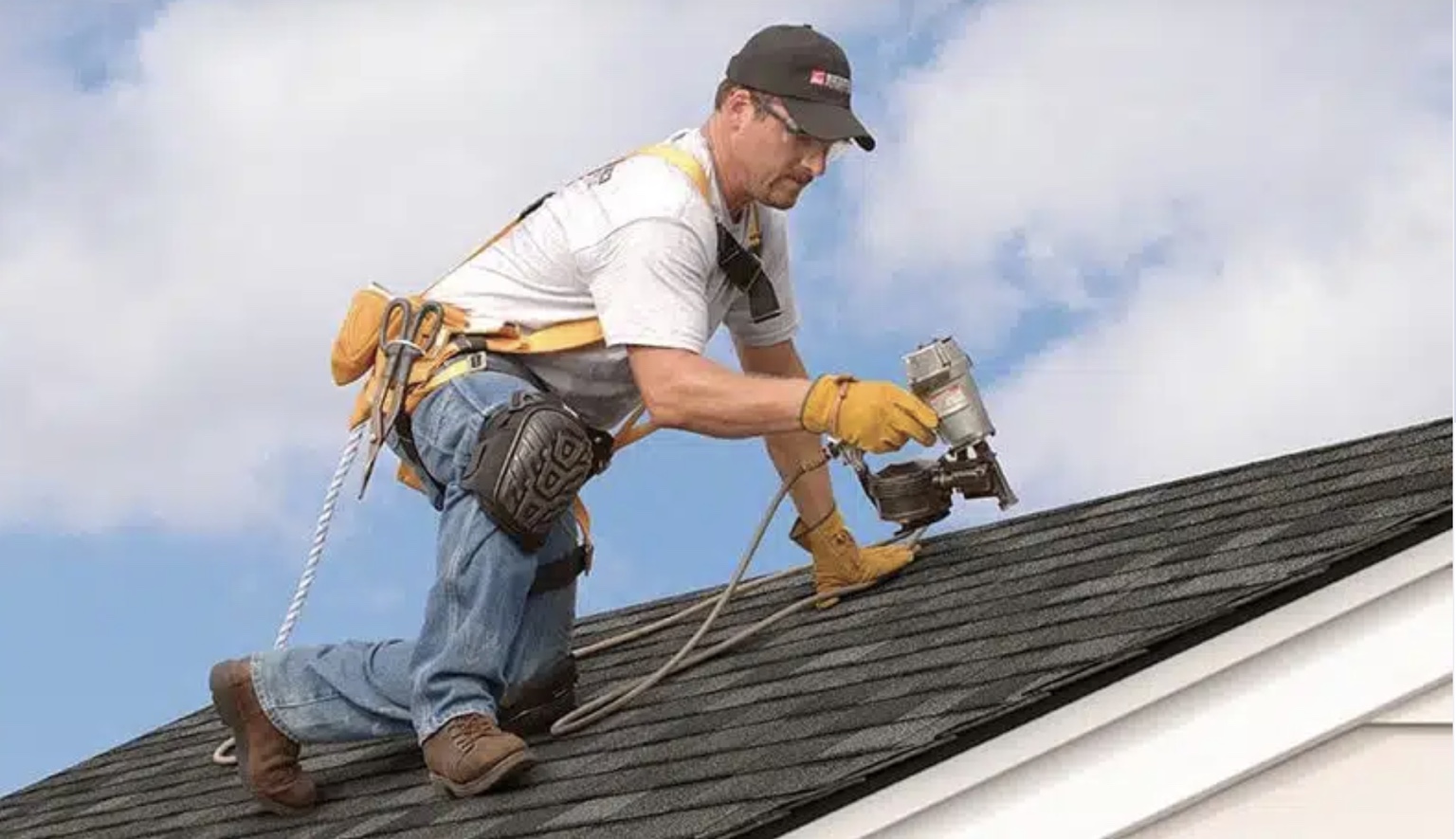 Roofer installing shingles