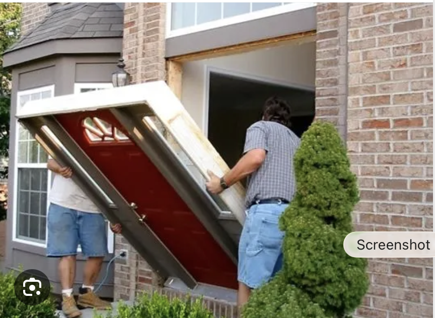 Crew installing exterior door